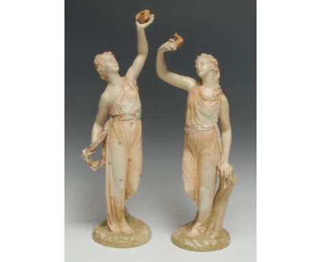 A pair of Royal Worcester figure, Allegorical of Liberty and Captivity, they stands holding aloft a dove, one in  open palm, 