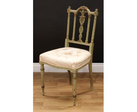 An Adam Revival painted and parcel-gilt side chair, arched cresting rail applied with flowers and stiff leaves, turned ear fi