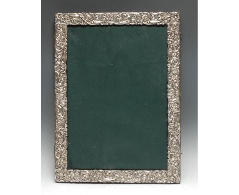 An unusually large Victorian silver rectangular easel photograph frame, the border pierced and embossed with exotic birds and