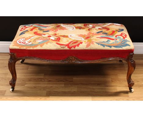 A large Victorian walnut stool, stuffed-over bead and woolwork upholstery, shaped apron, cabriole legs carved with flowers an