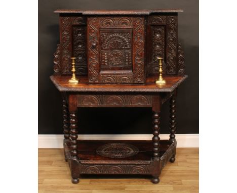 A late Victorian oak side cabinet, the superstructure with moulded top carved with a geometrically stylised egg-and-dart edge