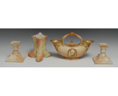 A pair of Royal Worcester boudoir candlesticks, in relief with cartouches and swags, 11.5cm high, printed mark in puce, date 