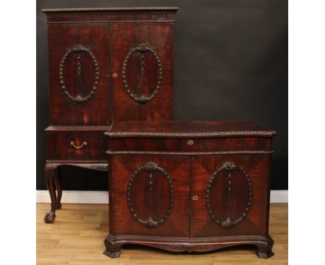 A matched suite of George II Revival mahogany cabinet furniture, comprising a cabinet on stand and a serpentine commode à van