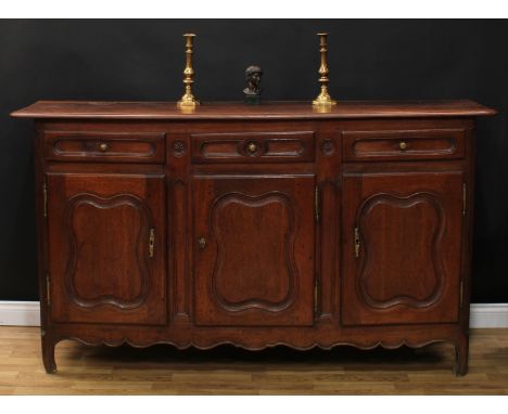 A large 19th century South European oak low dresser, moulded rectangular top with inset plate channel above three frieze draw