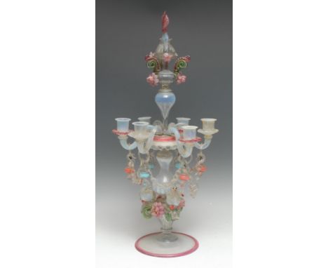 An Italian glass six-light candelabrum, decorated throughout in tones of pink, blue, green and vaseline with flowerheads, swa