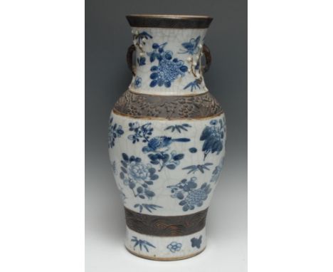 A large Chinese ovoid vase, painted in tones of underglaze blue with peonies, birds, insects and blossoming branches, on a cr