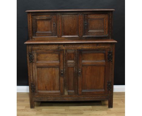 An '18th century' oak duodarn or court cupboard, rectangular top with moulded edge above two panel doors enclosing a shelf, t