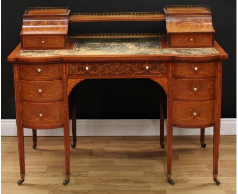 A late Victorian Sheraton Revival mahogany and marquetry writing desk, shaped superstructure with brass gallery and an incurv