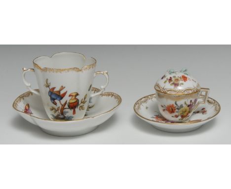 A Dresden Helena Wolfshen lobed two handled cabinet cup and saucer, decorated with fanciful birds and insects, gilt foliage b