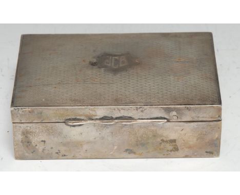 A George V silver rectangular cigarette box, hinged engine turned cover, cedar lined, 13cm wide, Birmingham 1928 