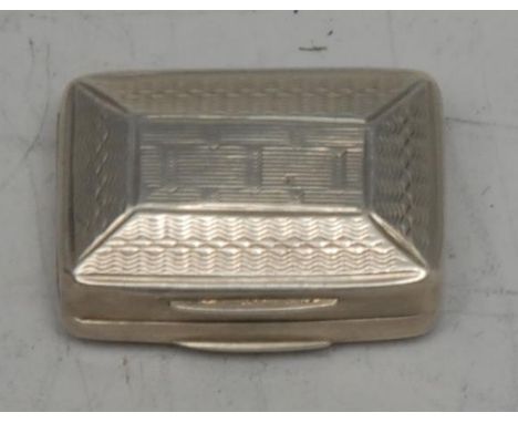 An early Victorian silver rounded rectangular vinaigrette, engine turned, hinged cover enclosing a pierced grille, 2.75cm wid