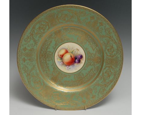 A Royal Worcester cabinet plate, painted by Christopher Hughes, sighed with ripe fruit in a circular cartouche, the mint grou