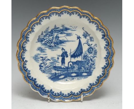 A Caughley Fisherman pattern shaped circular dessert plate, printed in underglaze blue, cell border above diapers, outlined w