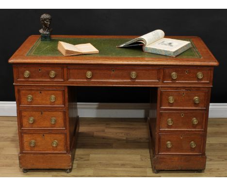 A Victorian oak twin pedestal desk, rounded rectangular top with inset tooled and gilt leather writing surface, above three c