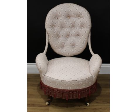 A Victorian bedroom chair, shaped oval deep-button back, stuffed-over upholstery, turned forelegs, ceramic casters, 81cm high