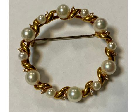 A modern diamond and cultured pearl brooch, inset with twelve creamy white globular pearls and twelve brilliant cut diamond a