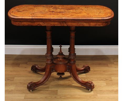 A Victorian walnut and marquetry card table, hinged discorectangular top inlaid with stylised anthemions within a heart-shape