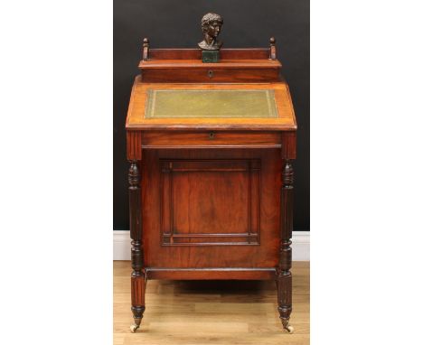 A Victorian walnut Davenport desk, rectangular superstructure with three-quarter gallery enclosing an interior fitted for wri