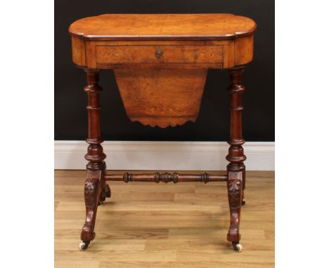 A Victorian walnut and marquetry work table, slightly oversailing top inlaid in boxwood with scrolling leaves, above a frieze