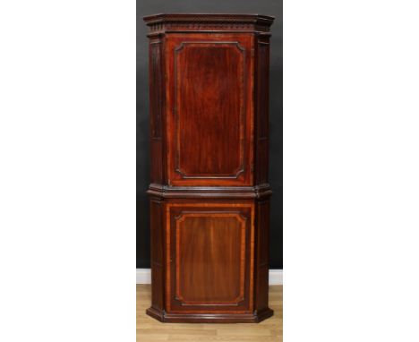 A 19th century walnut crossbanded mahogany floor standing corner cabinet, meandrous cornice above a panel door enclosing thre