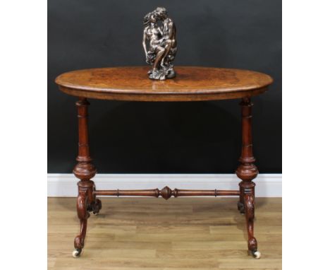 A Victorian walnut and marquetry centre table, oval quarter-veneered top inlaid in boxwood with bell husks and scrolling leav