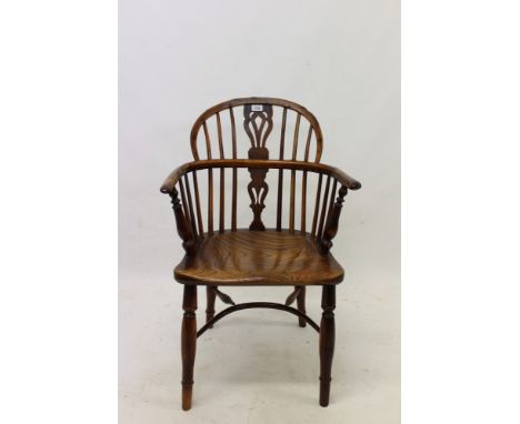 Early 19th century yew and elm stick back elbow chair with crinoline stretcher.