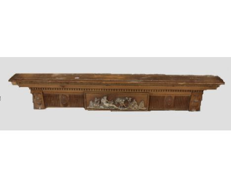 19th century Adam-style pine mantel shelf, with carved stiff-leaf and egg and dart carved borders, central classical relief f
