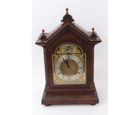 Late 19th century mantel clock with eight day spring-driven movement striking on a bell, brass breakarch dial with scroll spa