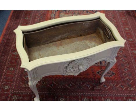 Early 20th century cream painted planter by Jas. Schoolbred, of serpentine form with relief floral ornament, with metal liner
