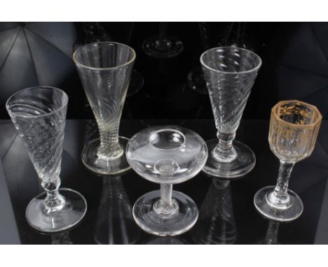Three Georgian wrythen ale flutes, a gilt decorated liqueur glass and a lace makers' lamp (5)
