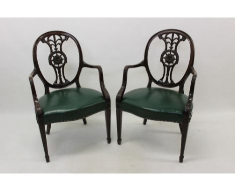 Pair of Chippendale-style mahogany open armchairs, each with heavily carved roundel back, centred by roundel and Prince of Wa