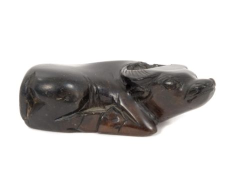 Japanese carved hardstone netsuke in the form of a reclining water buffalo, 7cm long