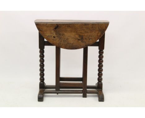 Rare 17th century oak drop leaf table, on bobbin turned ends and simple gates, sledge base, 66cm wide