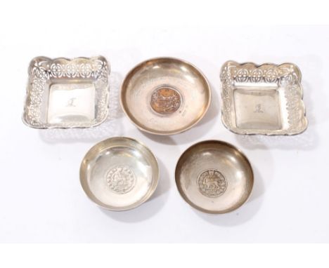 Pair of 1920s silver trinket trays of square form, with engraved armorial crests, wavy borders and pierced decoration. (Birmi