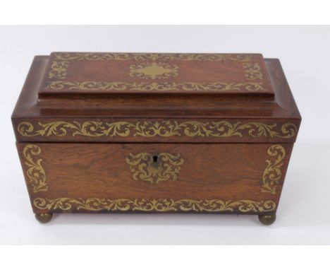 Regency rosewood and brass inlaid sarcophagus form tea caddy, with flanking loop handles, the hinged cover enclosing central 