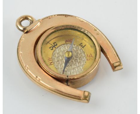 Gold plated horseshoe watch fob with agate face and compass, 3.5cm long.  