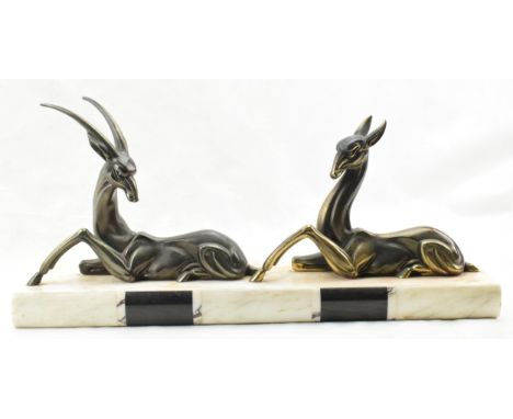 French Art Deco spelter figures of a gazelle and a deer mounted on a marble base, 50cm long.  