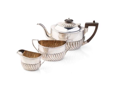 Hallmarked silver tea set to include a teapot, milk and sugar bowl, 388.0 grams / 12.48 oz gross weight, with ebonised handle