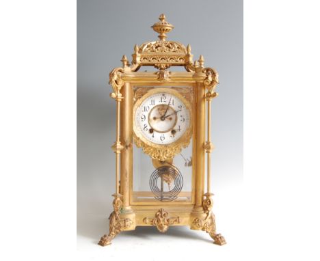A late 19th century gilt metal four glass mantel clock, having Baroque influenced case, white enamel dial with visible escape