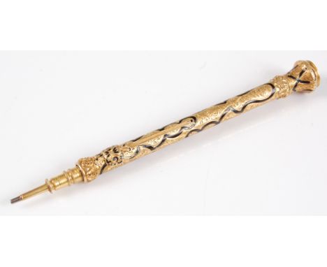 A Victorian yellow metal and enamelled propelling pencil, having all-over foliate engraved decoration with further sinuous en