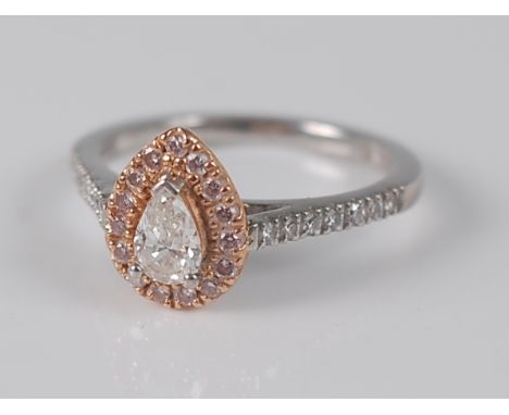 A platinum and 18ct rose gold pear shaped cluster ring, featuring a centre pear cut diamond within a border of 15 round brill