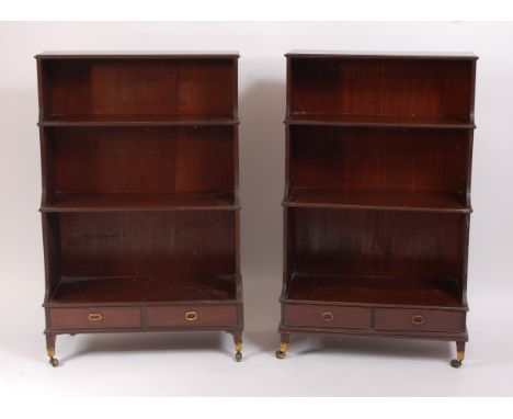 A well matched pair of 19th century mahogany waterfall bookcases by Gillows of Lancaster, each having three graduated tiers o