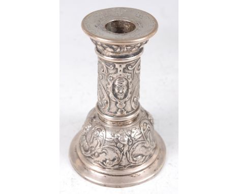 A late 19th century continental silver table candlestick, probably French, the sconce with a frieze of fruit, the column reli