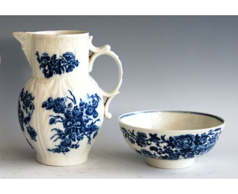 A late 18th century Caughley cabbage leaf moulded mask jug, blue and white printed with sprigs of flowers, S mark verso, h.19
