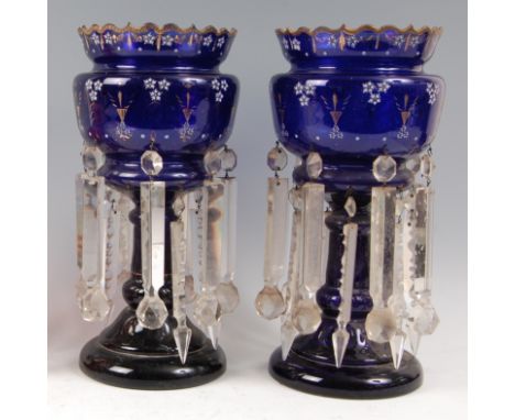 A pair of Victorian Bristol blue glass pedestal lustres, each with traces of gilt and enamel decoration, having faceted glass
