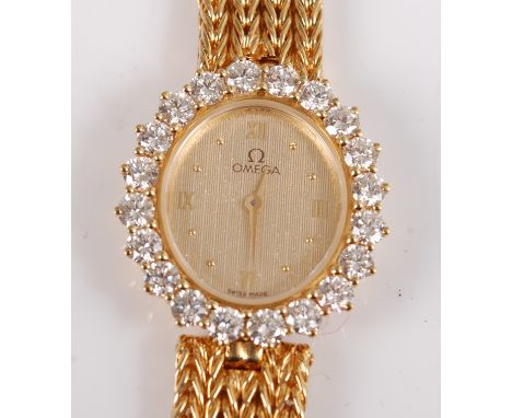 An 18ct yellow gold lady's Omega quartz wristwatch, the watch having an oval quarter Roman dial with an outer bezel of twenty