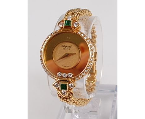 An 18ct yellow gold lady's Chopard 'Happy Diamonds' manual wind wristwatch, the watch having a round champagne dial with thre