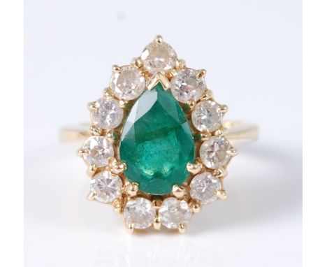 An 18ct yellow gold pear shaped emerald and diamond cluster ring, featuring a centre pear shaped emerald within a border of e