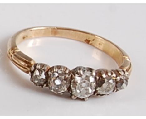 A late Victorian yellow and white metal five stone diamond half hoop ring, the five graduated old cushion cut diamonds measur