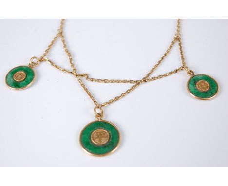 A Chinese yellow metal and jade necklace, supporting three green jade circular pendants, each with yellow inset Chinese chara